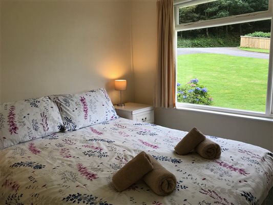 Double bedroom. Ground floor with view over large lawn